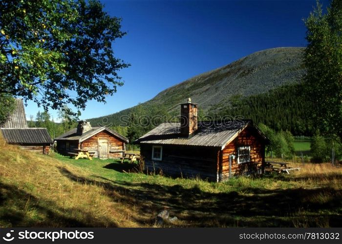 Cabins in the mountain with sunshine and blue sky