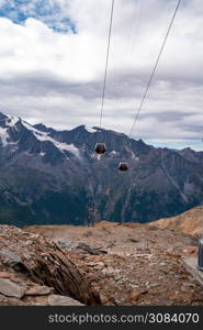 Cable Car in Swiss Alps over beautiful mountain landscape, Switzerland in Europe, beautiful ice and rock landscape cloudy. Cable Car in Swiss Alps over beautiful mountain landscape, Switzerland in Europe, beautiful ice and rock landscape