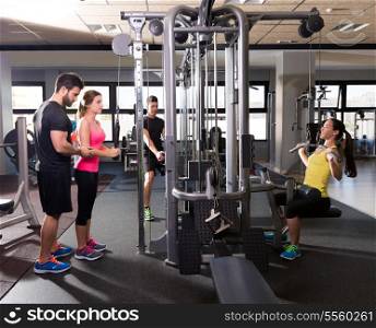 cable pulley system gym workout fitness people with personal trainer