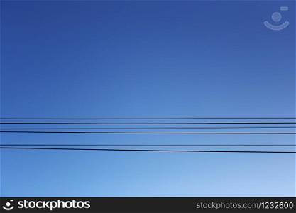 Cable wires of the electric poles on blue sky background for design in your work concept.