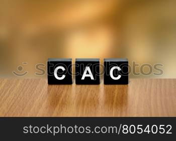 CAC or customer acquisition cost on black block with blurred background