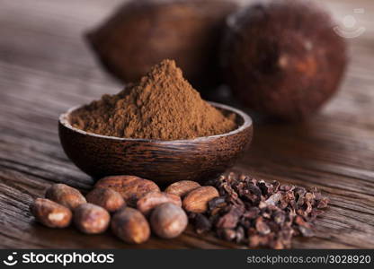 Cacao beans and powder and food dessert background. Cocoa beans in the dry cocoa pod fruit on wooden background