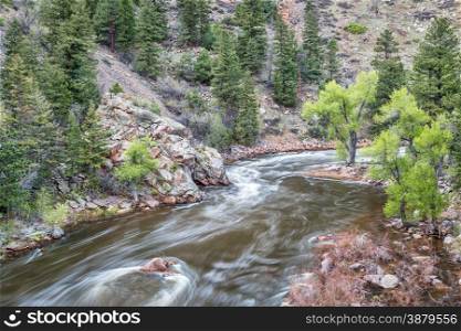Cache la Poudre River at Big Narrows west of Fort Collins in northern Colorado - springtime scenery with a snow melt run off