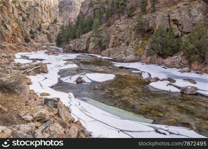 Cache la Poudre River at Big Narrows west of Fort Collins in northern Colorado - winter scenery with a partially frozen river