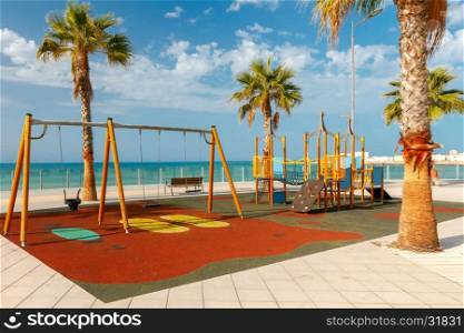 Cadiz. City embankment.. Children colorful playground on the waterfront of Cadiz. Spain. Andalusia.