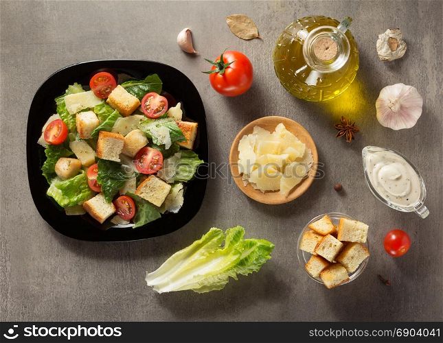 caesar salad and ingredients at table background