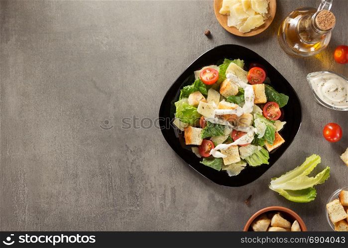 caesar salad and ingredients at table background