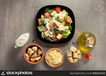 caesar salad and ingredients at table background