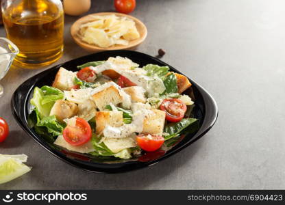 caesar salad and ingredients at table background