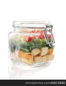 caesar salad in glass jar isolated on white background