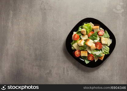 caesar salad in plate at table background