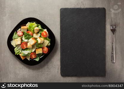 caesar salad in plate at table background