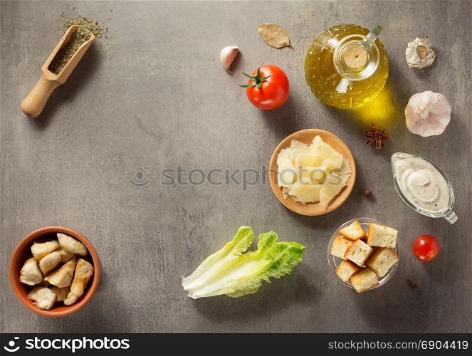 caesar salad ingredients at stone table background