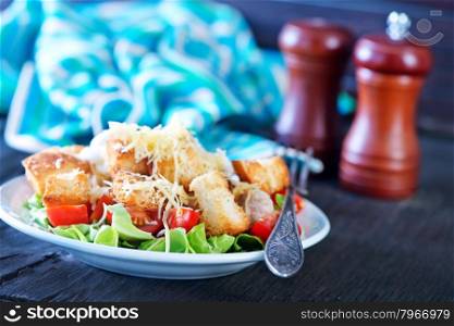 caesar salad on plate and on a table