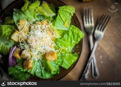 Caesar salad on rustic background