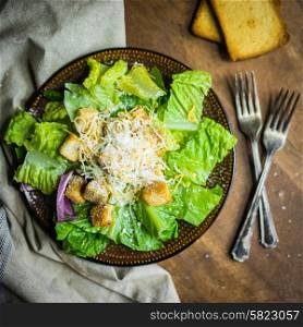 Caesar salad on rustic background