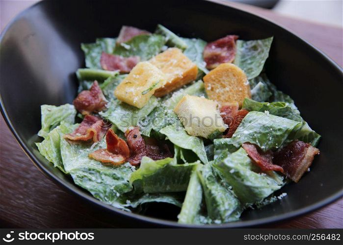 caesar salad on wood background