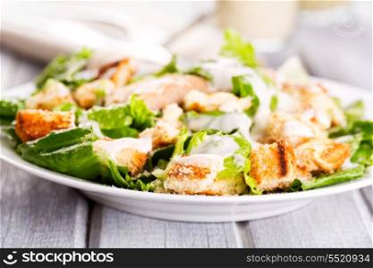 Caesar salad on wooden table