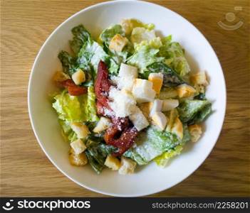  caesar salad placed on top of a wooden table
