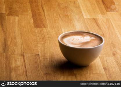 Cafe latte on a wood table with copy space