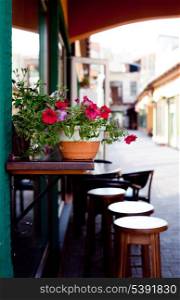Cafe&rsquo;s chairs outdoors, decorated with flowers