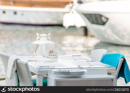 cafe table is located on the pier near the sea