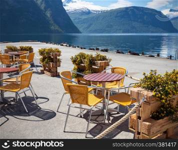 cafe. tables and chairs on the shore of the fjord in Norway