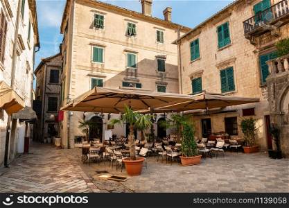Cafe tables on cozy street of old town. Kotor, Montenegro