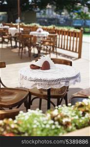 Cafe with rustic tableware and chairs outdoors