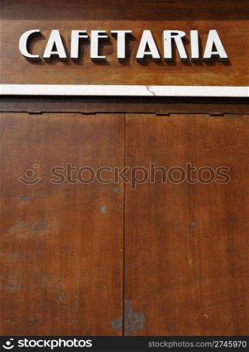 cafetaria sign (in english would be coffee house) on a wooden background