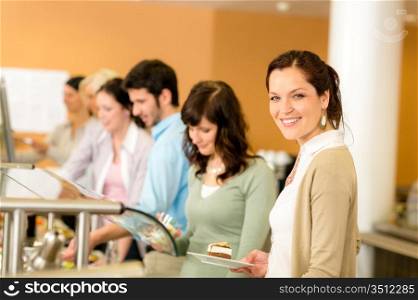 Cafeteria food young woman choose dessert self service buffet