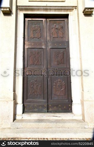 cairate abstract rusty brass brown knocker in a door curch closed wood italy lombardy
