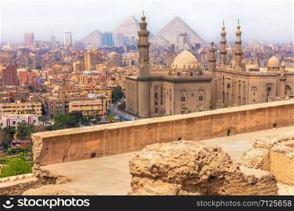 Cairo view, the Mosque-Madrassa of Sultan Hassan and the Pyramids, Egypt.