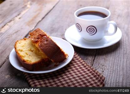 cake and cup of coffee on a vintage wooden table