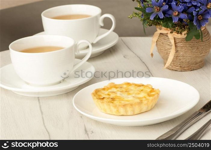 cake and cup of coffee with flowers on the table. cake and cup of coffee on the table