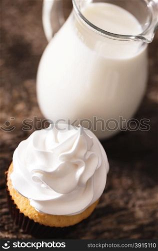 Cake cupcakes with white cream and skim milk carafe top