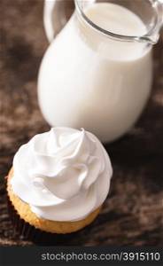Cake cupcakes with white cream and skim milk carafe top