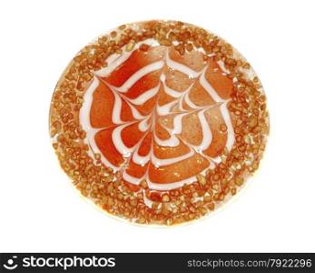 Cake decorated with red berry jelly and crushed nuts isolated