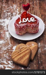 cake in the shape of heart with the inscription love and bunch of berries of viburnum