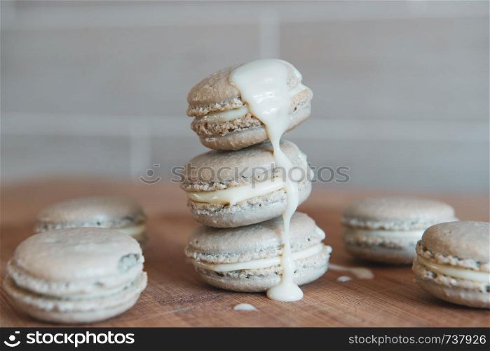 Cake macaron or macaroon with cream on grey background, sweet and colorful dessert.. Cake macaron or macaroon with cream on grey background, sweet and colorful dessert