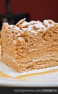 Cake Napoleon closeup . Cake Napoleon at plate closeup photo