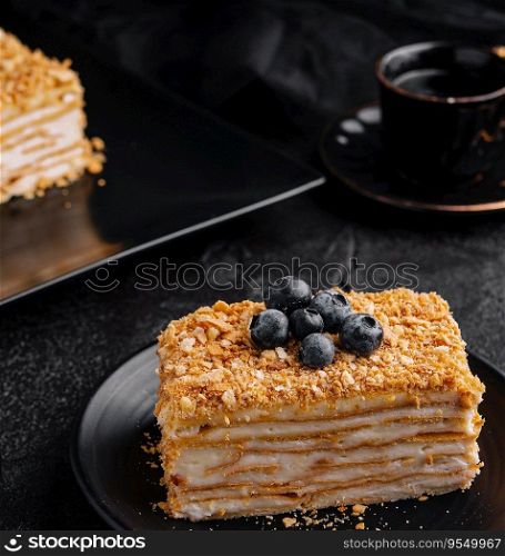 cake napoleon with blue blueberries and tea cup