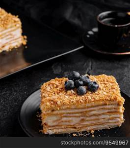 cake napoleon with blue blueberries and tea cup