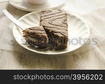 cake on a white plate. cake on a white plate standing on the wooden background