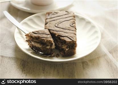 cake on a white plate. cake on a white plate standing on the wooden background