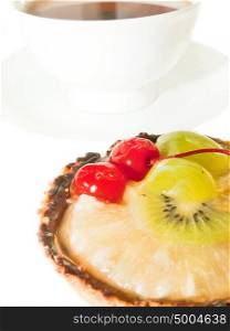 Cake with Berries and fruits over white. cup of tee on background