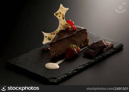 cake with berries on many decorative stone dark background. cake with berries on a dark background