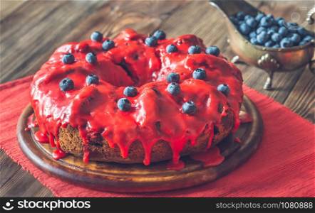 Cake with blueberries on the wooden board