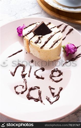 "cake with chocolate served at plate with "nice day" sign. life style concept"
