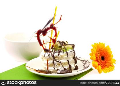 cake with cream caramel heart and Gerbera lying on a green cloth